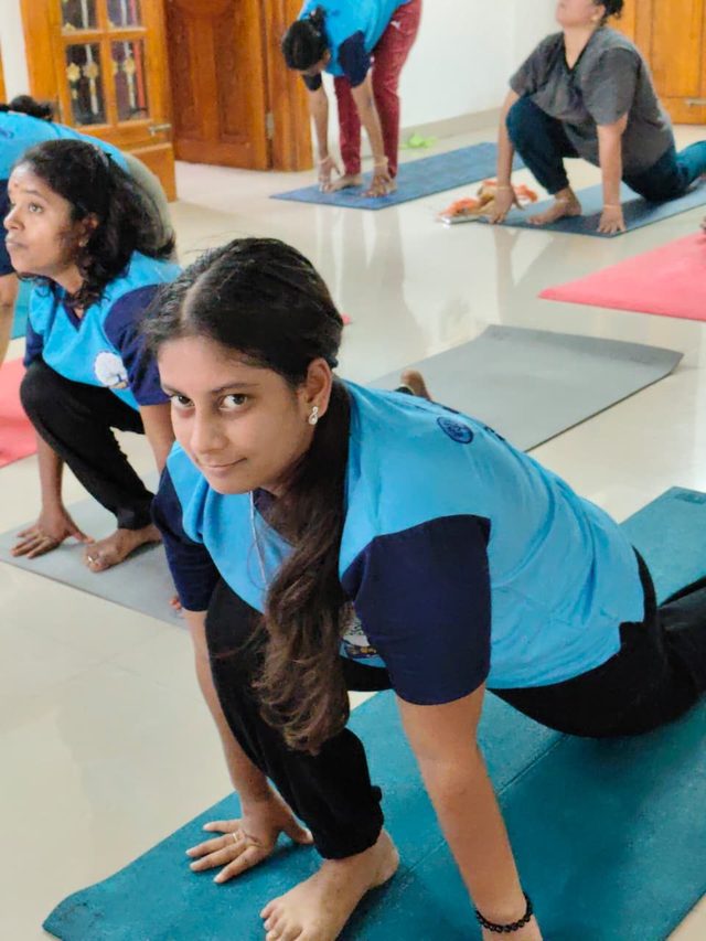 Ladies batch moving through cat-cow stretches