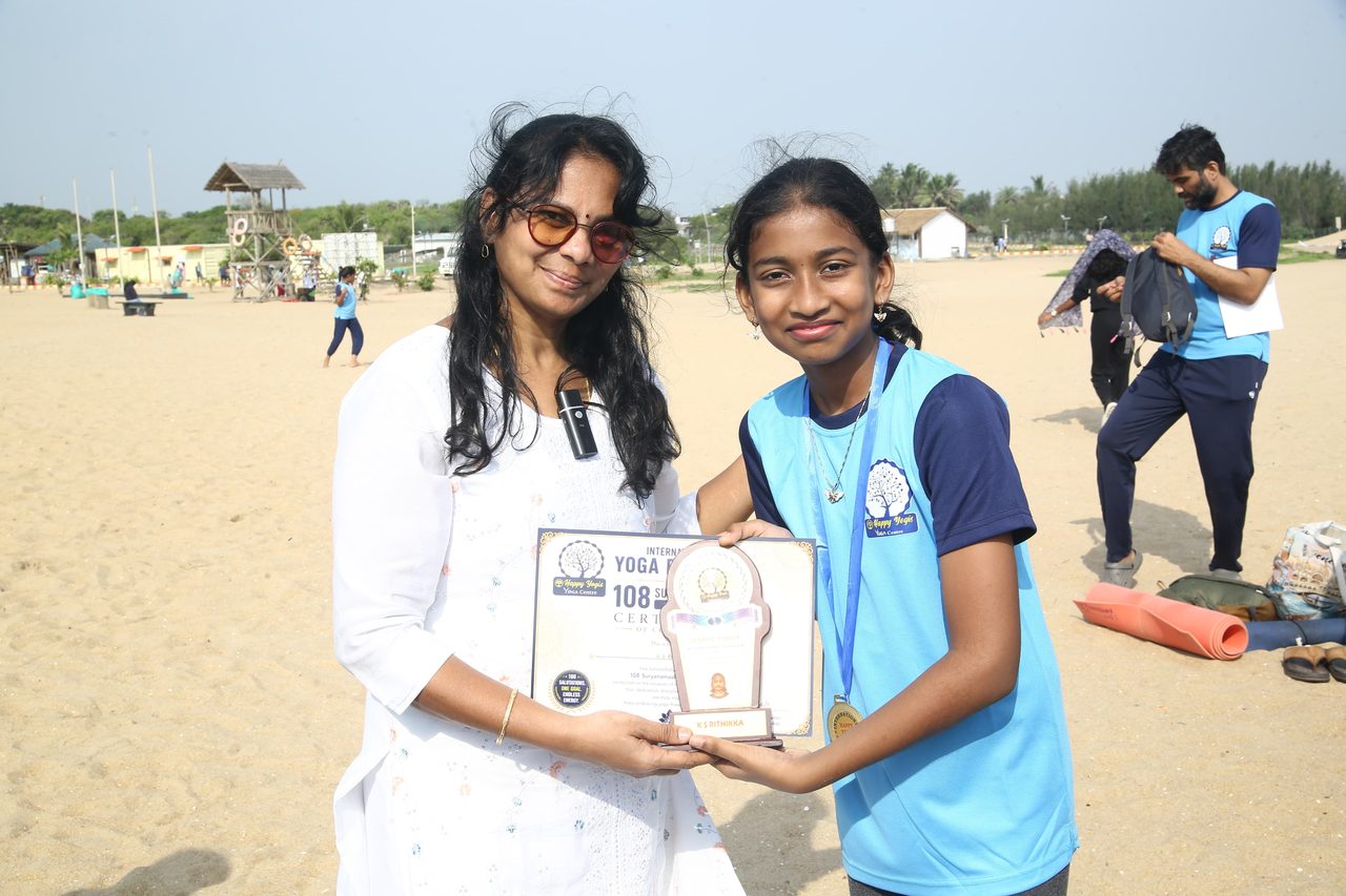 A young student receiving her certificate and memento