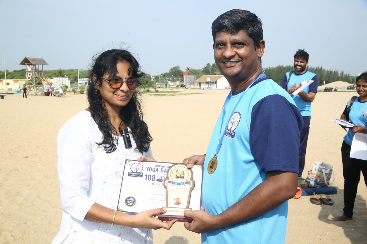A finisher receiving his certificate and memento