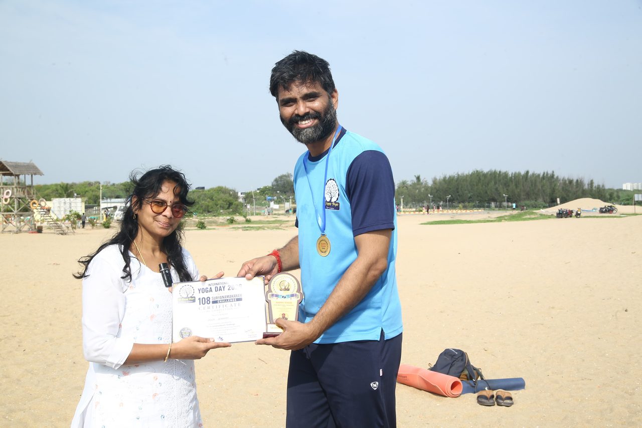 A finisher with his medal, receiving his certificate
