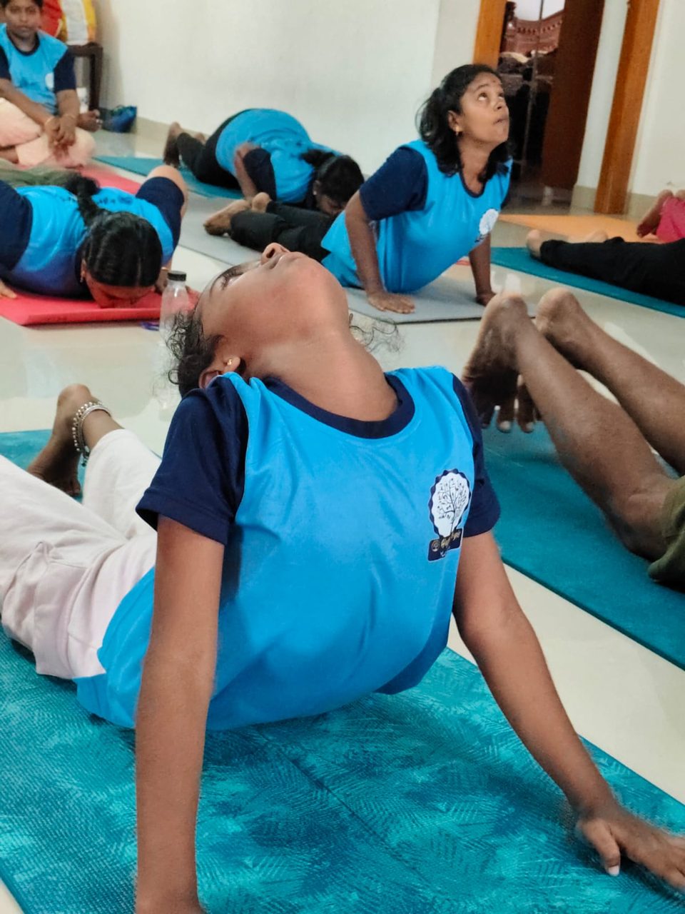 Children practising cobra pose in a class at Happy Yogis